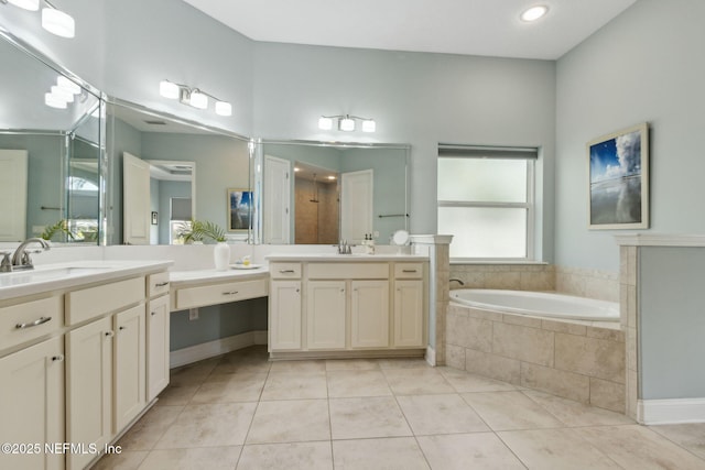 bathroom featuring a sink, tile patterned flooring, recessed lighting, and a bath