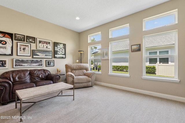 living area with baseboards, recessed lighting, and carpet