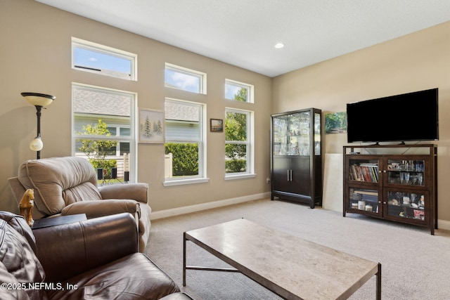 carpeted living area with baseboards