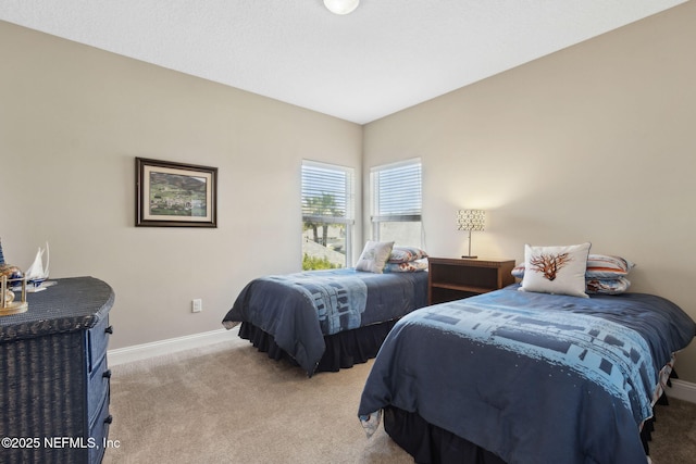 bedroom featuring baseboards and light colored carpet