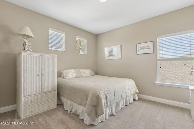 carpeted bedroom featuring baseboards