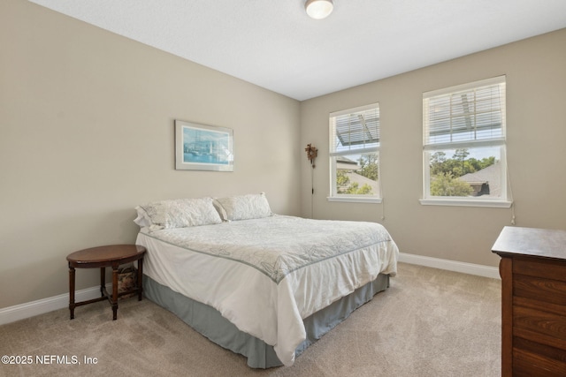 carpeted bedroom featuring baseboards