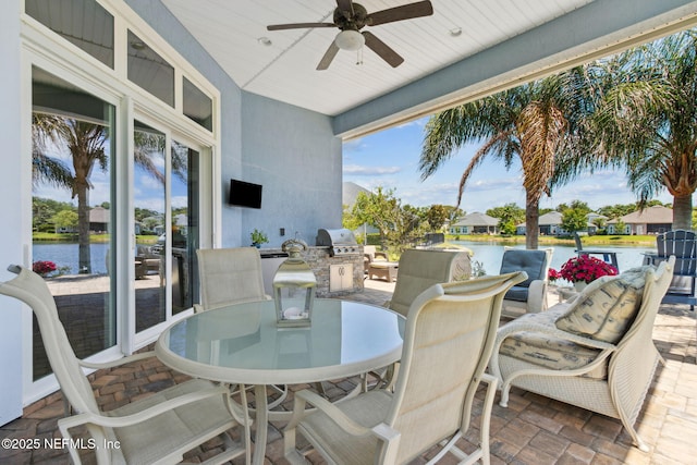 view of patio / terrace with exterior kitchen, outdoor dining area, a grill, and ceiling fan