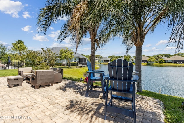 view of patio with a water view, fence, a residential view, and an outdoor hangout area