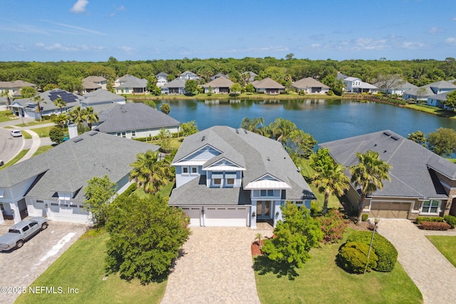 drone / aerial view with a water view and a residential view