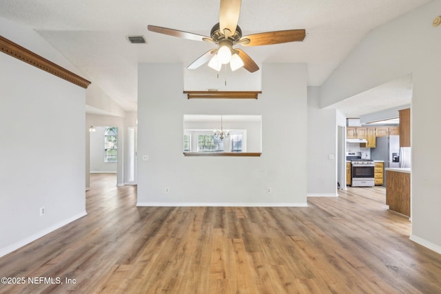 6085 Bermuda Dr, Fleming Island, FL 32003 - unfurnished living room featuring ceiling fan, light wood-style flooring, vaulted ceiling, a chandelier, and baseboards