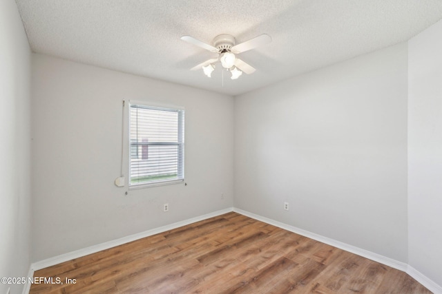 6085 Bermuda Dr, Fleming Island, FL 32003 - unfurnished room featuring wood finished floors, a ceiling fan, baseboards, and a textured ceiling