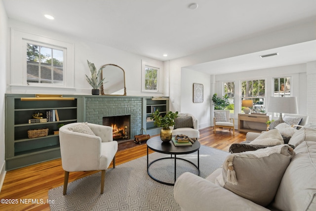2930 Apache Ave, Jacksonville, FL 32210 - living room featuring wood finished floors, a fireplace, plenty of natural light, and recessed lighting