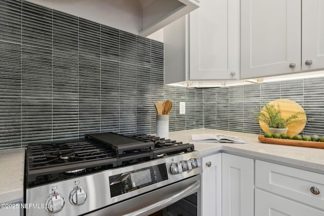 2930 Apache Ave, Jacksonville, FL 32210 - kitchen featuring stainless steel gas range, backsplash, white cabinets, and light stone countertops