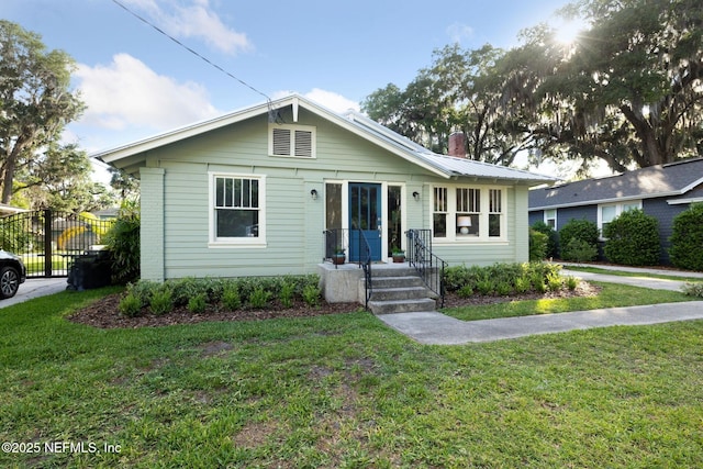2930 Apache Ave, Jacksonville, FL 32210 - bungalow-style home featuring a front yard and a chimney