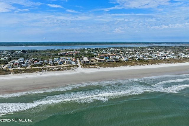 drone / aerial view with a beach view and a water view