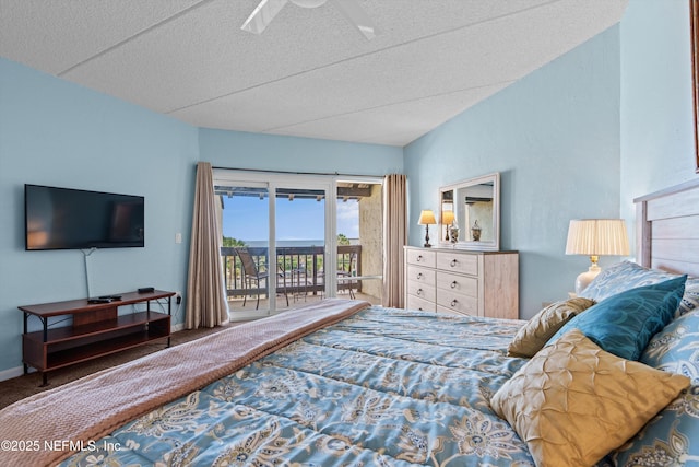 carpeted bedroom with a textured ceiling, access to exterior, and lofted ceiling