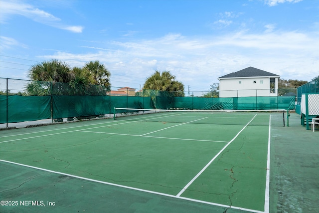 view of tennis court featuring fence