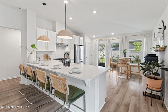 80 Boulder Ln, Saint Johns, FL 32259 - kitchen with high end fridge, backsplash, a breakfast bar, white cabinetry, and recessed lighting
