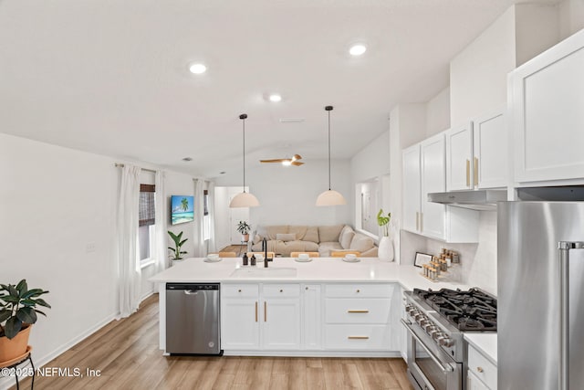 80 Boulder Ln, Saint Johns, FL 32259 - kitchen with appliances with stainless steel finishes, a sink, a peninsula, white cabinets, and light countertops