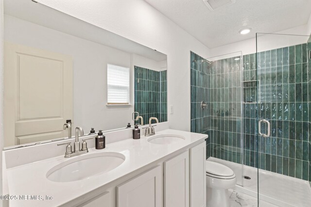 80 Boulder Ln, Saint Johns, FL 32259 - bathroom with toilet, a shower stall, double vanity, marble finish floors, and a textured ceiling