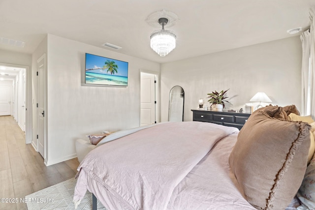 80 Boulder Ln, Saint Johns, FL 32259 - bedroom with light wood-style flooring, a chandelier, and baseboards