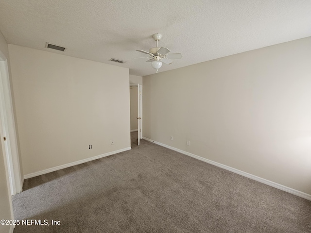 empty room featuring carpet floors, ceiling fan, visible vents, and baseboards