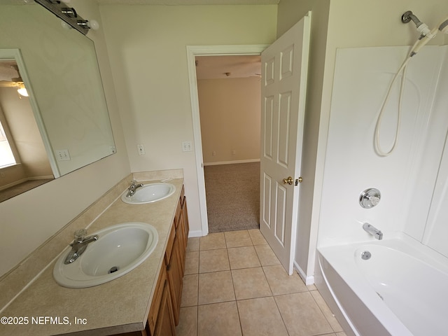 full bathroom with double vanity, washtub / shower combination, a sink, and tile patterned flooring