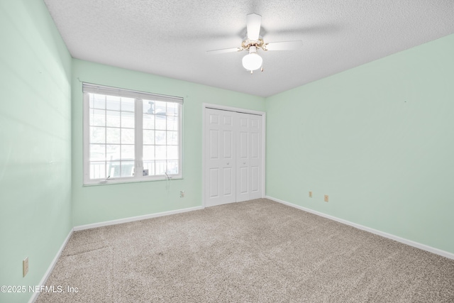 unfurnished bedroom featuring a closet, carpet flooring, and a textured ceiling