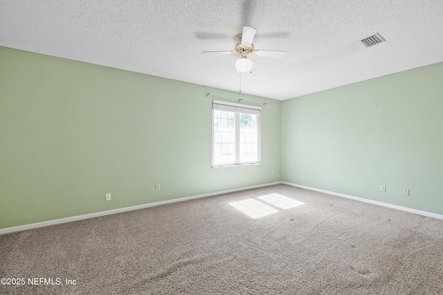 spare room with carpet floors, ceiling fan, and a textured ceiling