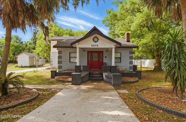 6878 Lenox Ave, Jacksonville, FL 32205 - bungalow-style house with fence, a chimney, and brick siding