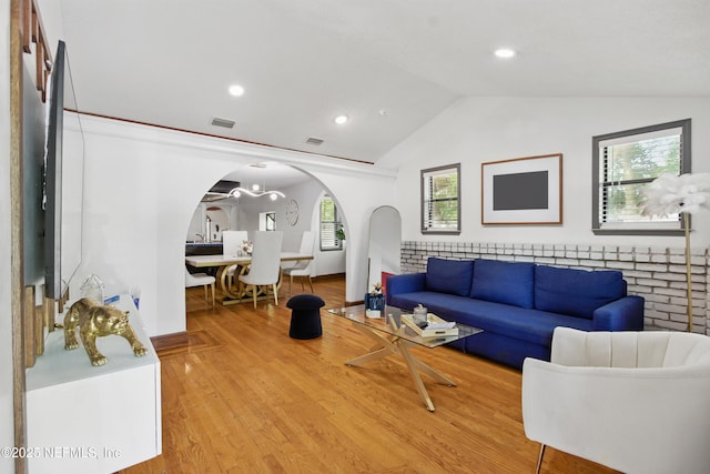 6878 Lenox Ave, Jacksonville, FL 32205 - living room featuring light wood finished floors, visible vents, arched walkways, recessed lighting, and vaulted ceiling