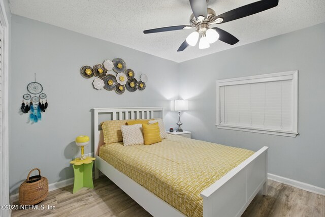6878 Lenox Ave, Jacksonville, FL 32205 - bedroom featuring a textured ceiling, baseboards, ceiling fan, and wood finished floors