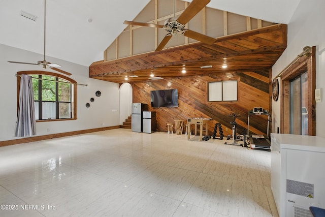 6878 Lenox Ave, Jacksonville, FL 32205 - unfurnished living room with a ceiling fan, high vaulted ceiling, wood walls, and arched walkways