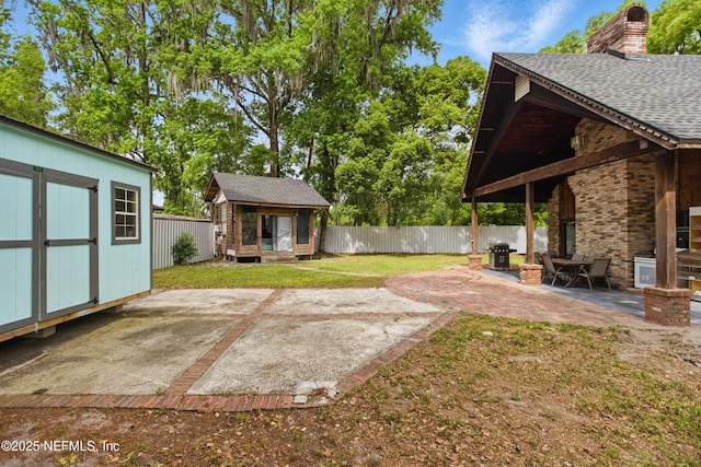 6878 Lenox Ave, Jacksonville, FL 32205 - view of yard with a fenced backyard, a patio area, and an outbuilding