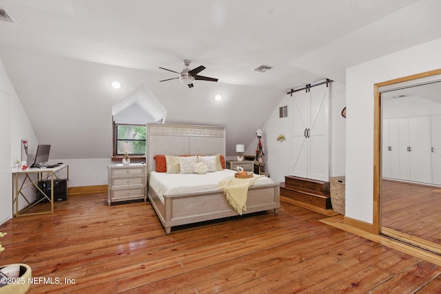 6878 Lenox Ave, Jacksonville, FL 32205 - bedroom with vaulted ceiling, visible vents, ceiling fan, and hardwood / wood-style flooring