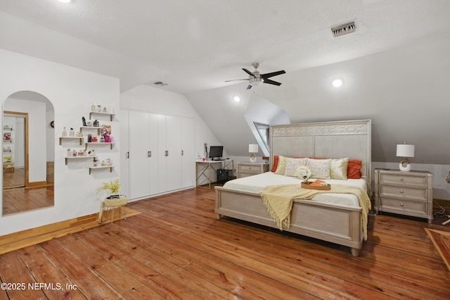 6878 Lenox Ave, Jacksonville, FL 32205 - bedroom featuring visible vents, arched walkways, lofted ceiling, and hardwood / wood-style flooring