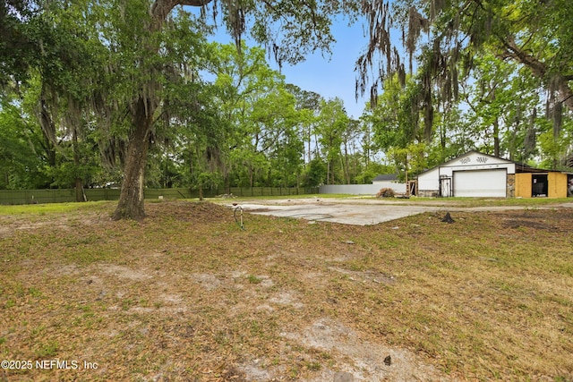 6878 Lenox Ave, Jacksonville, FL 32205 - view of yard featuring an outdoor structure, a garage, and fence