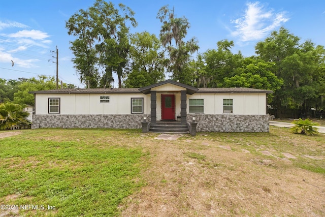 6878 Lenox Ave, Jacksonville, FL 32205 - manufactured / mobile home featuring a front yard and stone siding