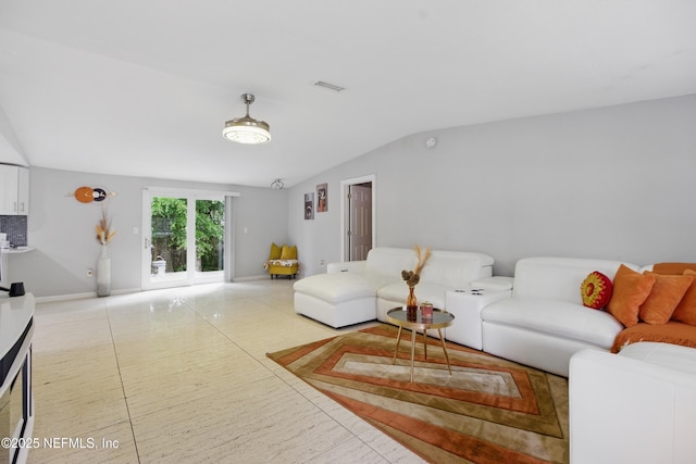 6878 Lenox Ave, Jacksonville, FL 32205 - living room with light tile patterned flooring, baseboards, visible vents, and lofted ceiling