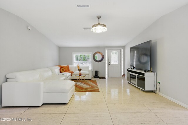 6878 Lenox Ave, Jacksonville, FL 32205 - living area with visible vents, baseboards, and light tile patterned flooring