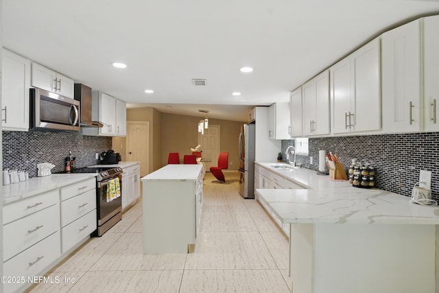 6878 Lenox Ave, Jacksonville, FL 32205 - kitchen featuring visible vents, a center island, light stone counters, a sink, and appliances with stainless steel finishes
