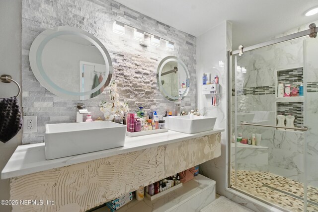 6878 Lenox Ave, Jacksonville, FL 32205 - full bathroom with a sink, a marble finish shower, decorative backsplash, and tile walls