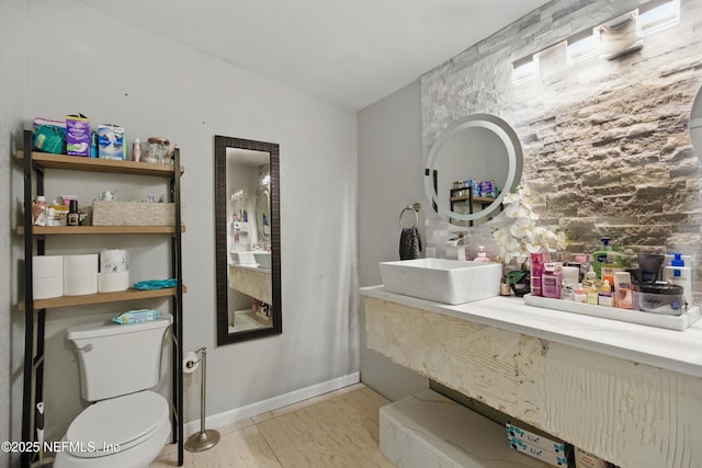 6878 Lenox Ave, Jacksonville, FL 32205 - bathroom with a sink, toilet, and wood finished floors