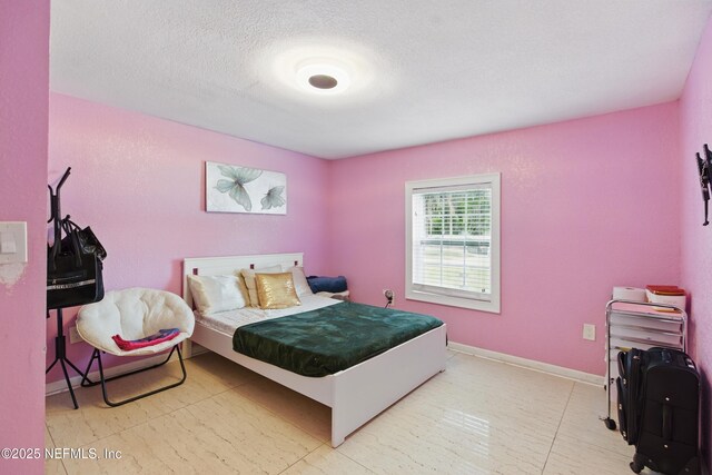 6878 Lenox Ave, Jacksonville, FL 32205 - bedroom featuring a textured ceiling and baseboards