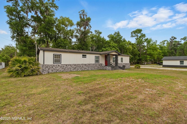 6878 Lenox Ave, Jacksonville, FL 32205 - manufactured / mobile home featuring a front yard and stone siding