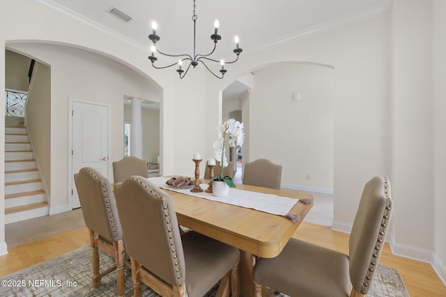 2762 Seagate Ave, Jacksonville Beach, FL 32250 - dining room with crown molding, arched walkways, a notable chandelier, and stairway