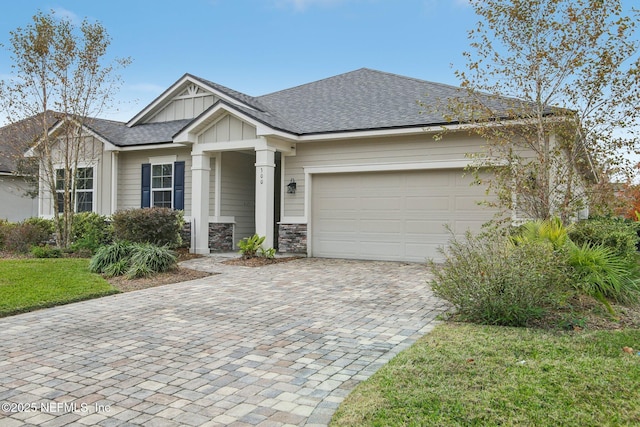 300 Downs Corner Rd, Saint Augustine, FL 32092 - view of front facade featuring board and batten siding, decorative driveway, roof with shingles, and a garage