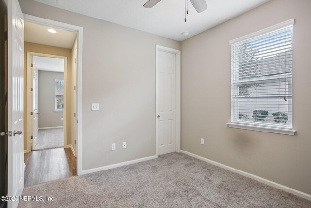 300 Downs Corner Rd, Saint Augustine, FL 32092 - unfurnished bedroom with carpet floors, baseboards, and multiple windows