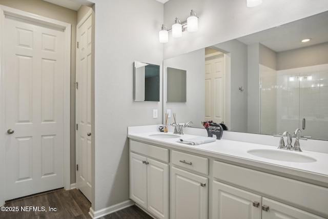 300 Downs Corner Rd, Saint Augustine, FL 32092 - bathroom featuring double vanity, a sink, wood finished floors, and a shower stall
