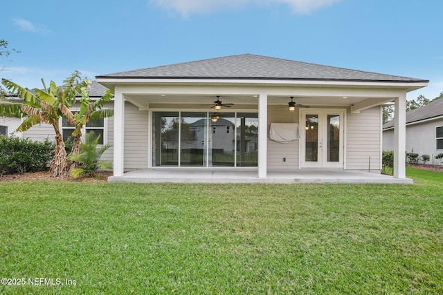 300 Downs Corner Rd, Saint Augustine, FL 32092 - back of house with a ceiling fan, french doors, roof with shingles, a lawn, and a patio area
