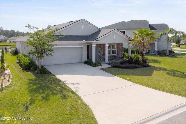 view of front facade with driveway, roof with shingles, a front lawn, an attached garage, and stone siding