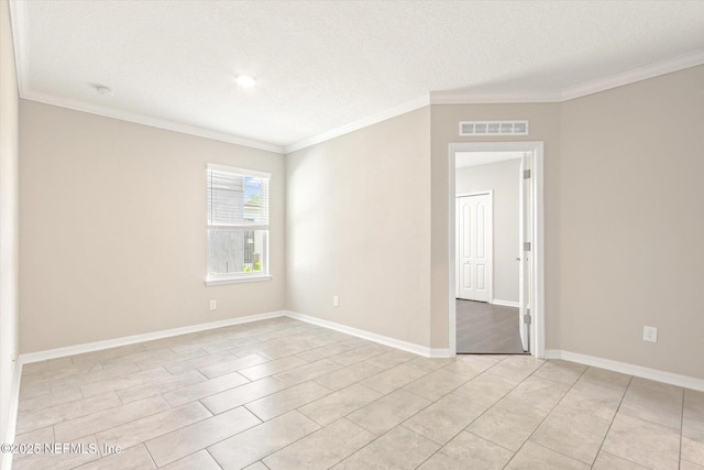spare room with visible vents, ornamental molding, and light tile patterned flooring