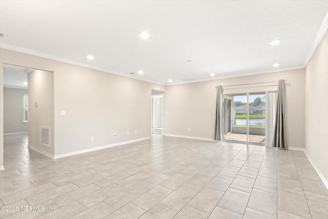 empty room with crown molding, recessed lighting, baseboards, and visible vents