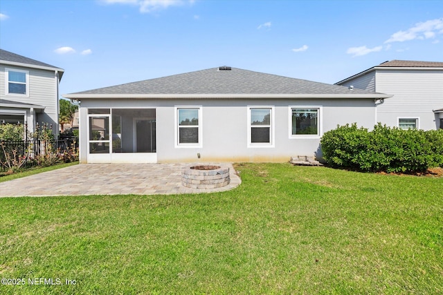 back of property with a fire pit, fence, stucco siding, a sunroom, and a patio area